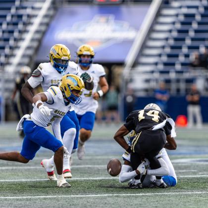 Osceola's Larenz Walker's hit on punt returner Kyle Andrews caused a fumble that Kowboy Jeff Banks tries to recover. PHOTO/TAYLOR MCFEE