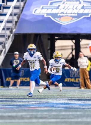 Osceola's Jamarrio Bradford (8) runs back an interception, with linebacker Nathaniel Barnett leading the way. PHOTO/TAYLOR MCFEE