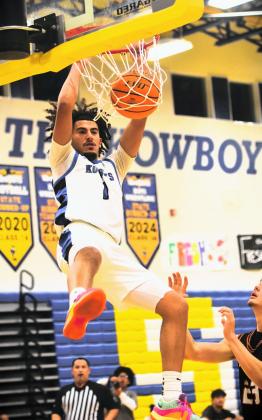 Throw it down, young man: Luke McCrimon dunks home two of his 11 points Wednesday. PHOTO/KATIE WILLIAMS