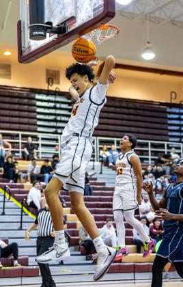 St. Cloud's Lenual Narvaez throws down a dunk in the Bulldogs' blowout win Wednesday over Lake Nona. Elias Torres (33) clearly approves. PHOTO/TAYLOR MCFEE