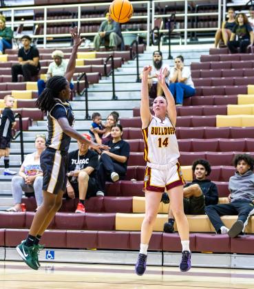 St. Cloud's Savannah Kroener shoots over an Oak Ridge defender for two of her 29 points in Thursday's 69-65 Bulldog regional playoff victory. PHOTO/TAYLOR MCFEE