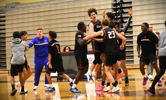 To the victors go the spoils -- and celebrations. Harmony wins the district title. PHOTO/KATIE WILLIAMS