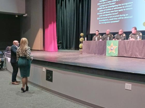 PHOTO/LARRY GRIFFIN Jorge Figueroa, president of the Puerto Rican Chamber of Commerce of Central Florida, asks an Osceola County Sheriff’s Office panel a question at Thursday’s immigration town hall meeting at Gateway High.
