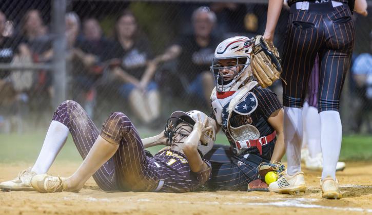 St. Cloud's Karly Kuchinskas slides into the tag of Harmony's catcher in Wednesday's district championship game. (Photo/Taylor McFee)
