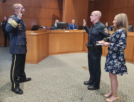 Kissimmee Police Chief Charles Broadway swears in Kevin McGinley as his new Assistant Police Chief at Tuesday’s City Commission meeting.  (Photo/Ken Jackson)
