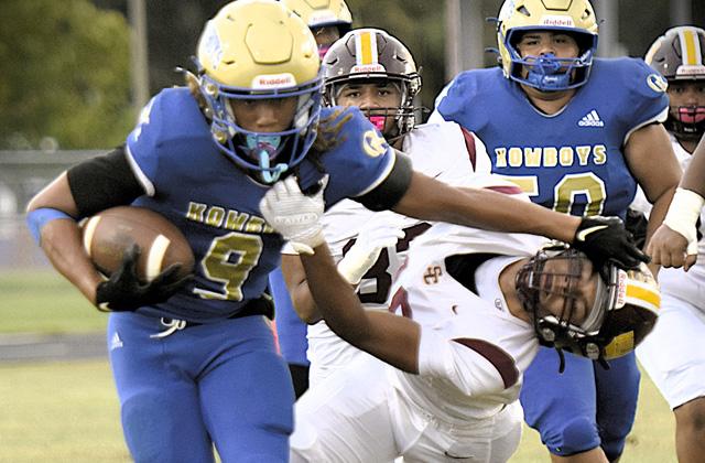 Osceola running back Jaxson Hardnett stiff arms a St. Cloud defender on his way to a big gain in Friday’s 44-7 win over the Bulldogs. (Photo/Katie Williams)