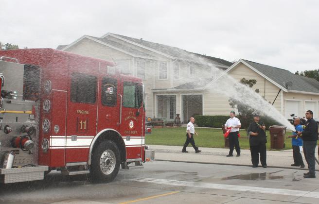Kissimmee Fire Department held a ceremonial “wet down and push back” for its Engine 11 at Fire Station 11 Tuesday. (Photo/Ken Jackson)