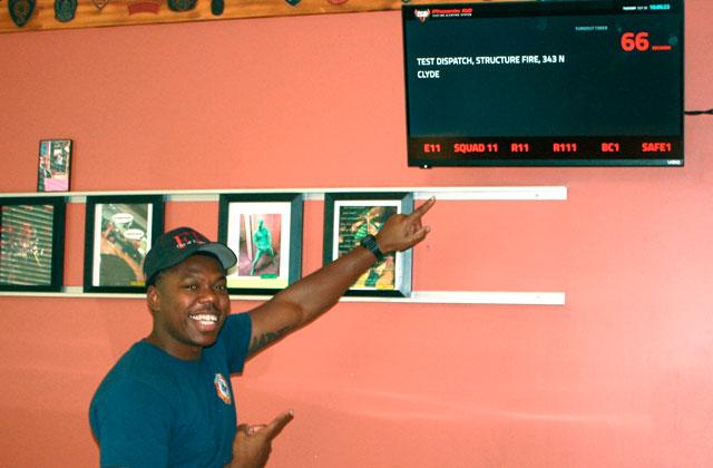 A Kissimmee Fire Department member of Station 11 shows off one of its Phoenix G2 screens. This one’s in the dining room. (Photos/ Christine Pike)