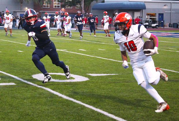 Tohopekaliga's AJ Wise gets upfield for yardage as Lake Brantley's Joseph Tesoriero closes in in the Patriots' 43-7 win Friday over the Tigers. (Photo/Ken Jackson)