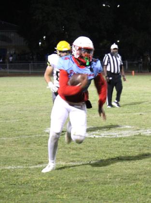 Poinciana's Daveon Williams rumbles for a chunk of his 107 rushing yards Friday. He also scored two touchdowns against Liberty. (Photo/Ken Jackson)