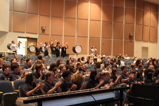 The members of the Harmony High School "Sound of the Stampede" marching band react Thursday to news they've been invited to participate in the London New Year's Day Parade on Jan. 1, 2027. (Photo/Ken Jackson)