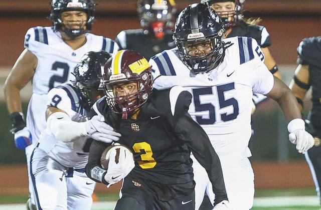 St. Cloud’s Stacy Taylor eludes Lake Nona defenders in the Bulldogs’ big 25-17 district win Friday. (Photo/Taylor McFee)