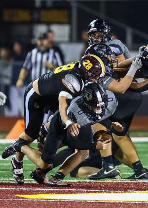 St. Cloud linebacker Dominic Cammarasana brings down Lake Nona quarterback Luke Ramsey in Friday's regional playoff quarterfinal. (Photo/Taylor McFee)