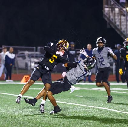 St. Cloud Bryce Williams hits Lake Nona receiver Cristian Cuffy in the third quarter of Friday's regional quarterfinal playoff game. (Photo/Taylor McFee)