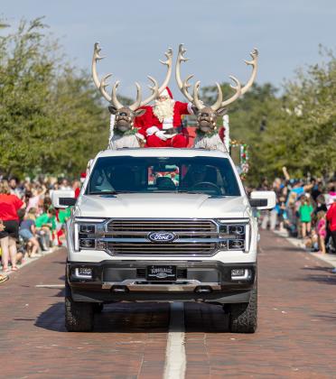 Santa rides shotgun with a pair of reindeer at Saturday’s annual St. Cloud Christmas parade. (Photo/Taylor McFee)
