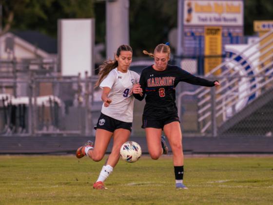 Celebration's Leandra Oliveira (9) and Harmony's Ashlyn Florio (8) fight for the ball in Friday's girls OBC championship game. (Photo/Mario Casamalhuapa)
