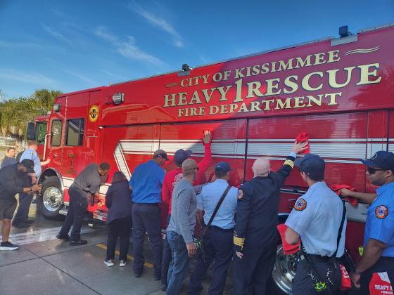 Kissimmee city and fire officials participate in Thursday's "wet down" and "push back" ceremony for Heavy Rescue 1 at Station 11. (Photo/Ken Jackson)