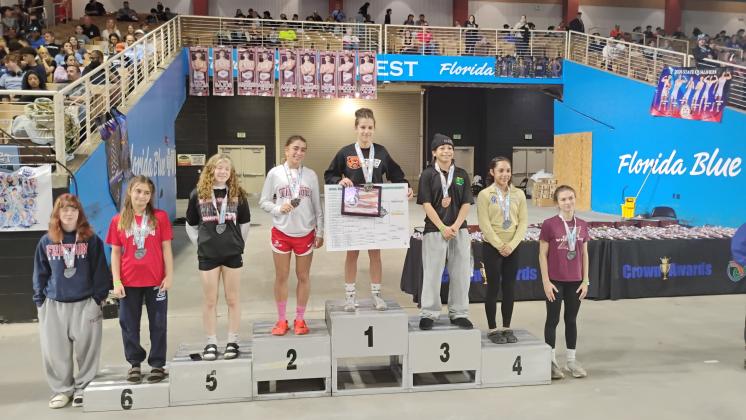 Osceola senior Aniyah Wayne (second from right) placed fourth at 100 pounds in the girls’ state wrestling championship. (Photo/J. Daniel Pearson)