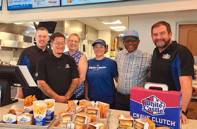From left, White Castle Vice President of Operations Mike Guinan, Regional Operations Director Theresa Kaszuvski, Crew Manager Juan Diaz, Lead Trainer Yarleen Arocho, Operating Manager Francis Nation and Chief Marketing Officer Jamie Richardson prep for Tuesday’s opening at a Monday preview event. The West 192 location is the chain’s third Central Florida location. (Photo/Ken Jackson)