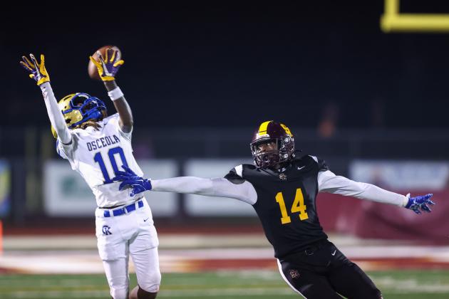 Almost Had It — Osceola's Ernest Hartfield and St. Clouds' Aiden Richardson go up for a pass in the Bulldogs' 18-15 win over the Kowboys, their first on the field since 2010. (Photo/Taylor McFee)