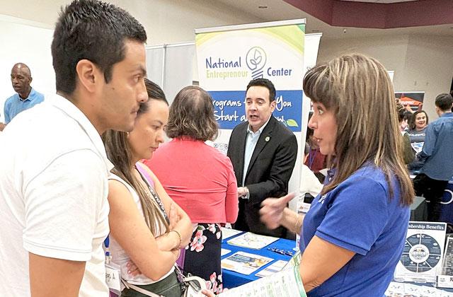 Diego and Vivian Acosta, business owners who recently moved to St. Cloud form Columbia, engage with Belinda Kirkegard, President of the National Entrepreneur Center, to learn about how to expand their lines of business. (Photo/Terry Lloyd)