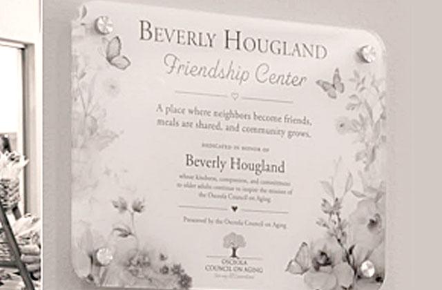 Warren and Chris Hougland unveil the Beverly Hougland Friendship Center plague at the Buen Vecino Ribbon Cutting ceremony. (Photo/Osceola Council on Aging)