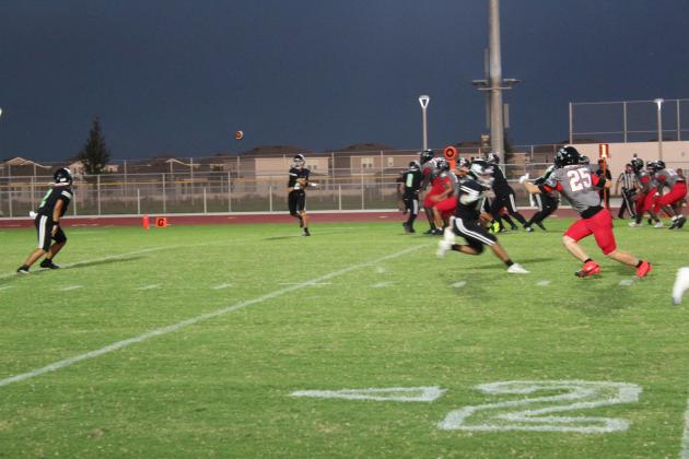Nova Lakes QB Josh Rodriguez hits a Jaden Dionisi on a swing pass on the Rattlers' first possession Friday against Palm Bay. (Photo/Ken Jackson)