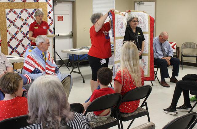 Tammy Fischer, a U.S. Army veteran form St. Cloud, is presented with her Quilt of Valor Saturday, Aug.8. (Photo/Terry Lloyd)