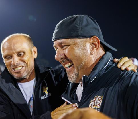 Past and present St. Cloud coaches Bryan Smart (left, the current Athletic Director) and Mike Short share a jubilant moment after the victory. (Photo/Taylor McFee) 