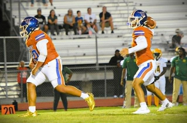 Harmony quarterback Lucas Haddad, who threw three touchdown passes Friday, uncorks a pass as running back Nick Bertaloni blocks. (Photo/Katie Williams)