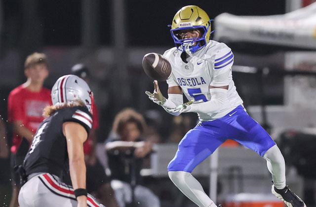 Osceola’s Amir Davis goes up for an interception, one of four Kowboy turnovers, in Friday’s 17-9 win over defending Class 6A state champ Lake Mary (Photo/Taylor McFee)