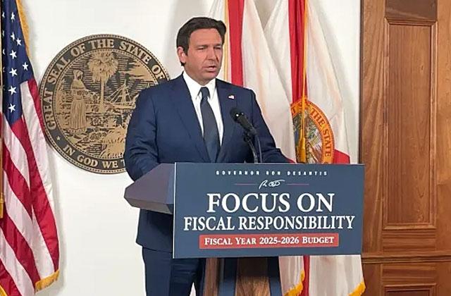 Gov. Ron DeSantis, shown releasing his proposed budget, wants a state “DOGE” to look for waste in government. (News Service of Florida Photo/Tom Urban)