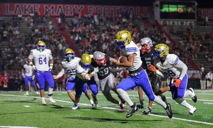 For the second week in a row, Osceola holder Josue Rivera ran for a touchdown off a bad kick snap, this one from 12 yards out that gave Osceola a 10-0 lead in the first half. (Photo/Taylor McFee)