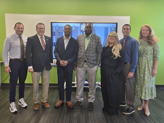 Members of the Osceola County School District, NeoCity Academy and The Osceola Chamber of Commerce celebrated Araoluwa Afolabi, center with his father, Abolasade. (Photo/Ken Jackson)