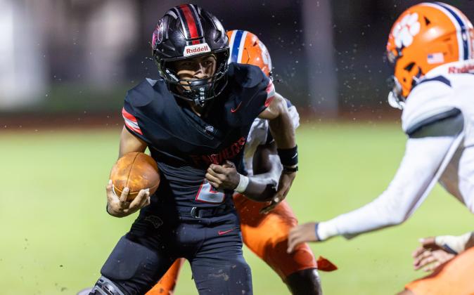 Gateway running back Johnny Reyes, who scored twice Friday, fights for yardage despite the Tigers' defense's best efforts. (Photo/Taylor McFee)
