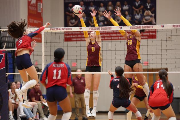 St. Cloud's Monica Gallagher (9) and Andrea Carradero (10) go up to block Freedom's Valeria Talavera's hit attempt in Thursday's District 6A-7 championship match. (Photo/Taylor McFee)