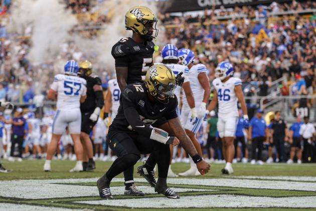 UCF quarterback Keyone Jenkins (12) celebrates scoring on a 1-yard sneak to give the Knights a lead in Saturday's game against BYU (Photo/Taylor McFee)