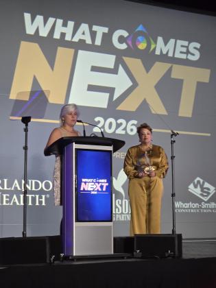 Outgoing Osceola County Commissioner Cheryl Grieb — to her surprise — was named former Commission Chair Viviana Janer's Person of the Year at Wednesday's Osceola State of the County Address at Osceola Heritage Park. (Photo/Ken Jackson)