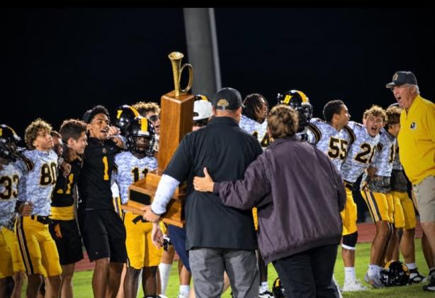 The St. Cloud Bulldogs react to getting and retaining the Brass Bugle trophy after narrowly defeating Harmony, 14-7, Friday. (Photo/Katie Williams)
