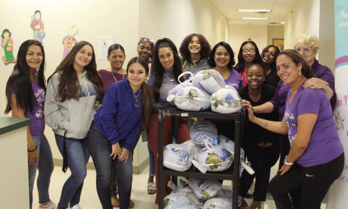 Current members, and alumni (“the Big Sisters”) of Teen Moms Choose Life help mentor Debbie Newell (far right) with its annual Thanksgiving turkey giveaway. Efforts to support the community for Christmas now start. PHOTO/KEN JACKSON