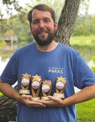 St. Cloud Parks &amp; Rec’s Oakley Gray displays the awards the city won in the 2025 SUNsational Awards for innovation and creative collaboration. (Photo/City of St. Cloud)