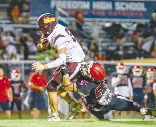 St. Cloud tight end Owen Sullivan powers through Freedom linebacker Adam Tababi in the Bulldogs’ 55-8 win Friday. (Photo/Taylor McFee)