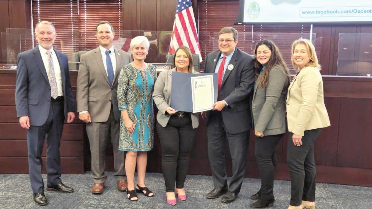 Retiring county administrator Dave Tomek (third from right, was honored with a proclamation by county commissioners and staff at the March 21 meeting. PHOTO/KEN JACKSON