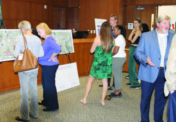 Attendees of an open house last week at Kissimmee City Hall review Kissimmee Gateway Airport’s master plan for the next 20 years. PHOTO/TERRY LLOYD