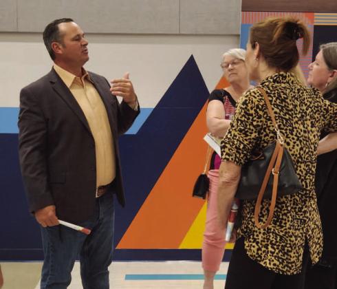 County Commissioner Ricky Booth goes over residents’ concerns who live in the rural enclave along Boggy Creek at the community meeting. PHOTO/KEN JACKSON