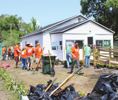 Many hands make light work on a very hot day for a St. Cloud veteran thanks to Osceola Council on Aging and Team Depot volunteer employees from the St. Cloud Home Depot. PHOTO/TERRY LLOYD