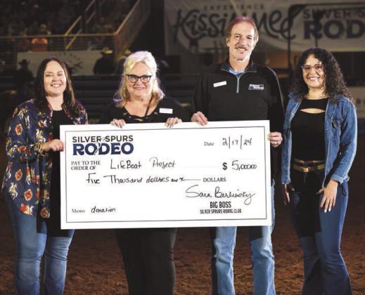 At Saturday night’s Silver Spurs Rodeo performance, the Silver Spurs Riding Club and Big Boss Sara Berlinsky (left) presented a $5,000 donation to The Lifeboat Project and CEO Jill Cohen (second from left). PHOTO/KATIE WILLIAMS