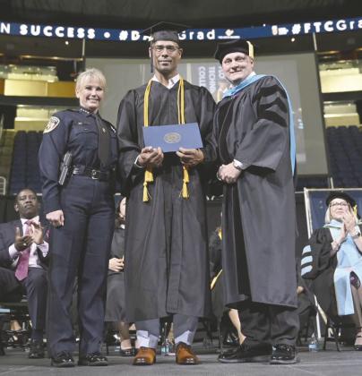 Kissimmee Police Lt. Omar Berrios (center), with KPD Chief Betty Holland and NUC Florida Technical College President Dr. James Michael Burkett at his graduation from the school’s bachelor’s degree program, will continue on scholarship in the school’s master’s program. PHOTO/KISSIMMEE POLICE DEPARTMENT
