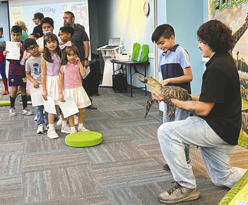 Local children enjoyed book readings, giveaways, games, and meeting an alligator at Early Learning Coalition’s launch of their new “Read to Rise” program at Hart Memorial Library on Friday. (Photos/Debbie Daniel)