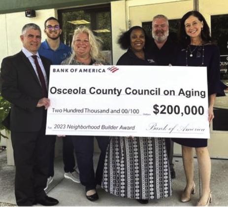 Bank of America’s Jodie Hardman (at right) present the award to OCOA board members and staff George Seda, Joseph Coschignano, Wendy Ford, Johnola Morales and Warren Hougland. PHOTO/OSCEOLA COUNCIL ON AGING